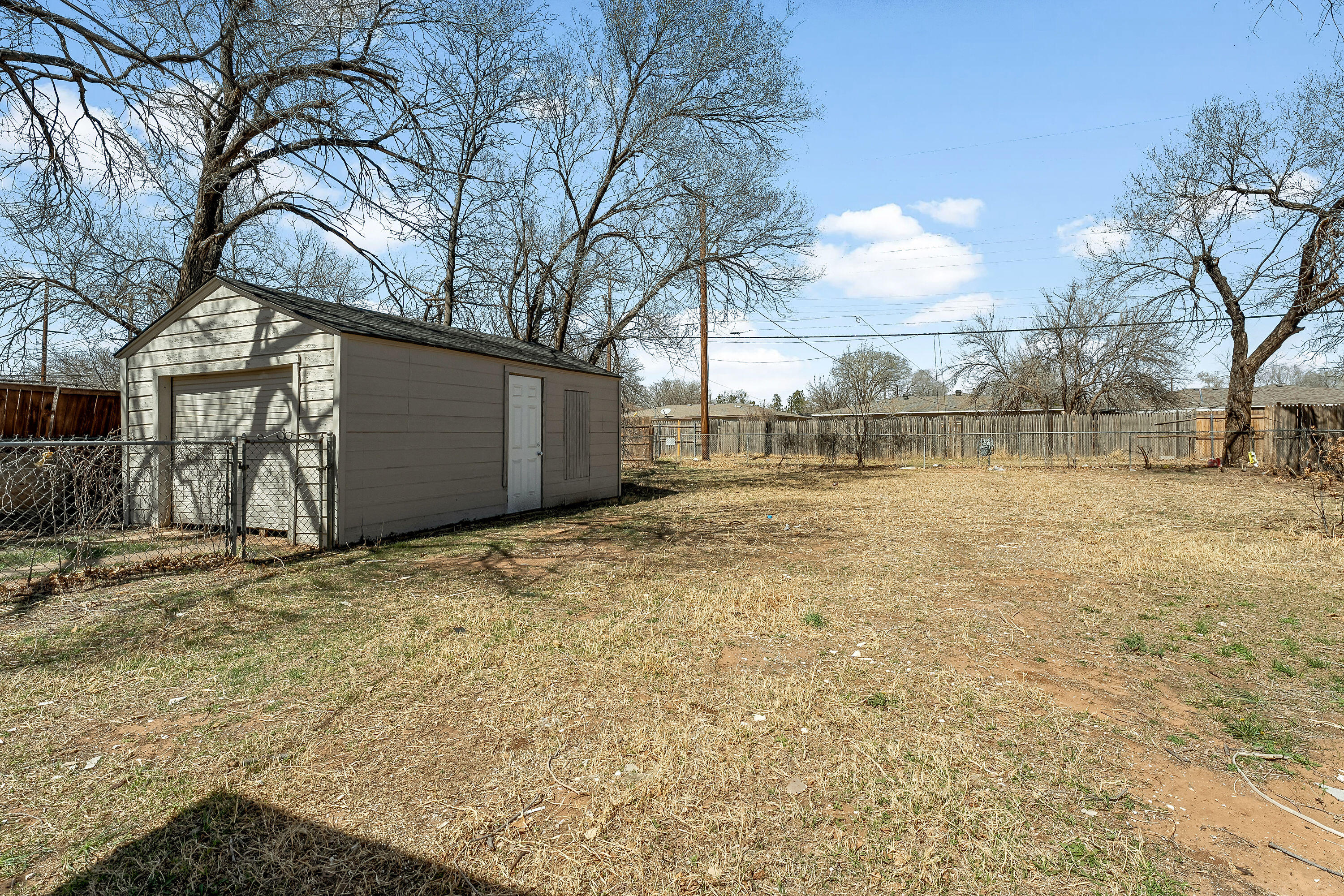 2814 40th Street Lubbock, TX 79413 - Photo 10 of 11 a backyard of house with large trees