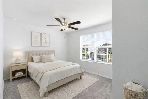 a bedroom with a large bed and a window
