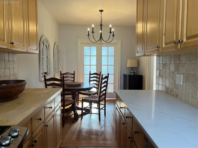 a kitchen with stainless steel appliances a sink stove and cabinets