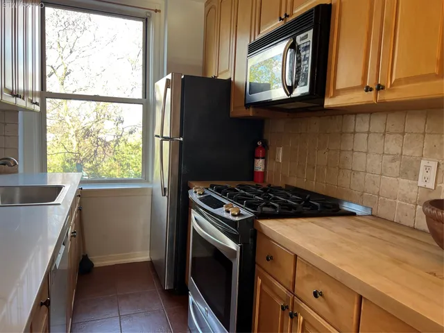 a kitchen with a sink a stove and cabinets