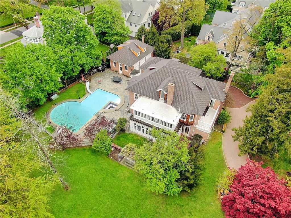 an aerial view of a house with garden space and street view