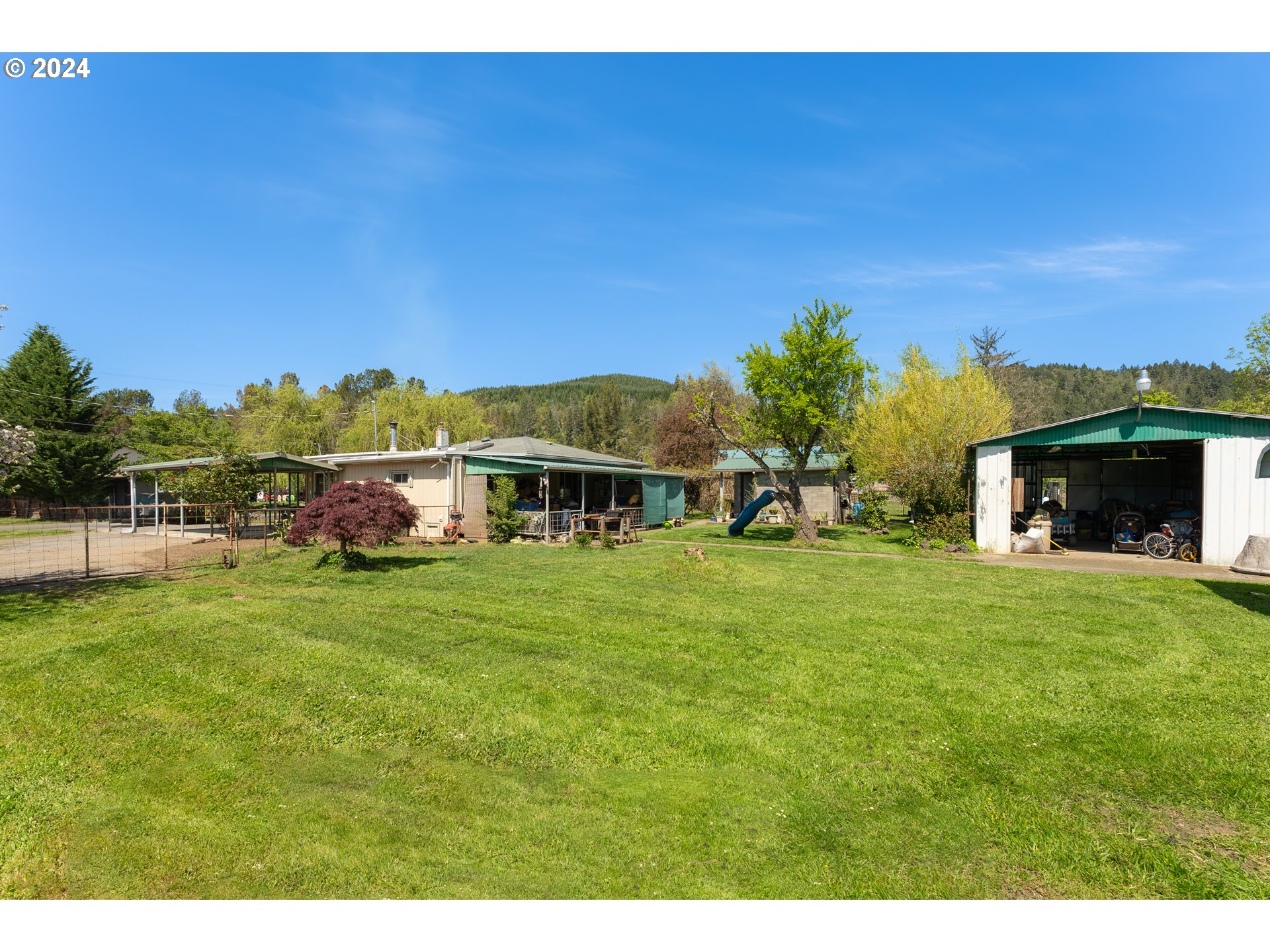 215 Northside Road Sutherlin, OR 97479 - Photo 27 of 40 a front view of a house with a garden