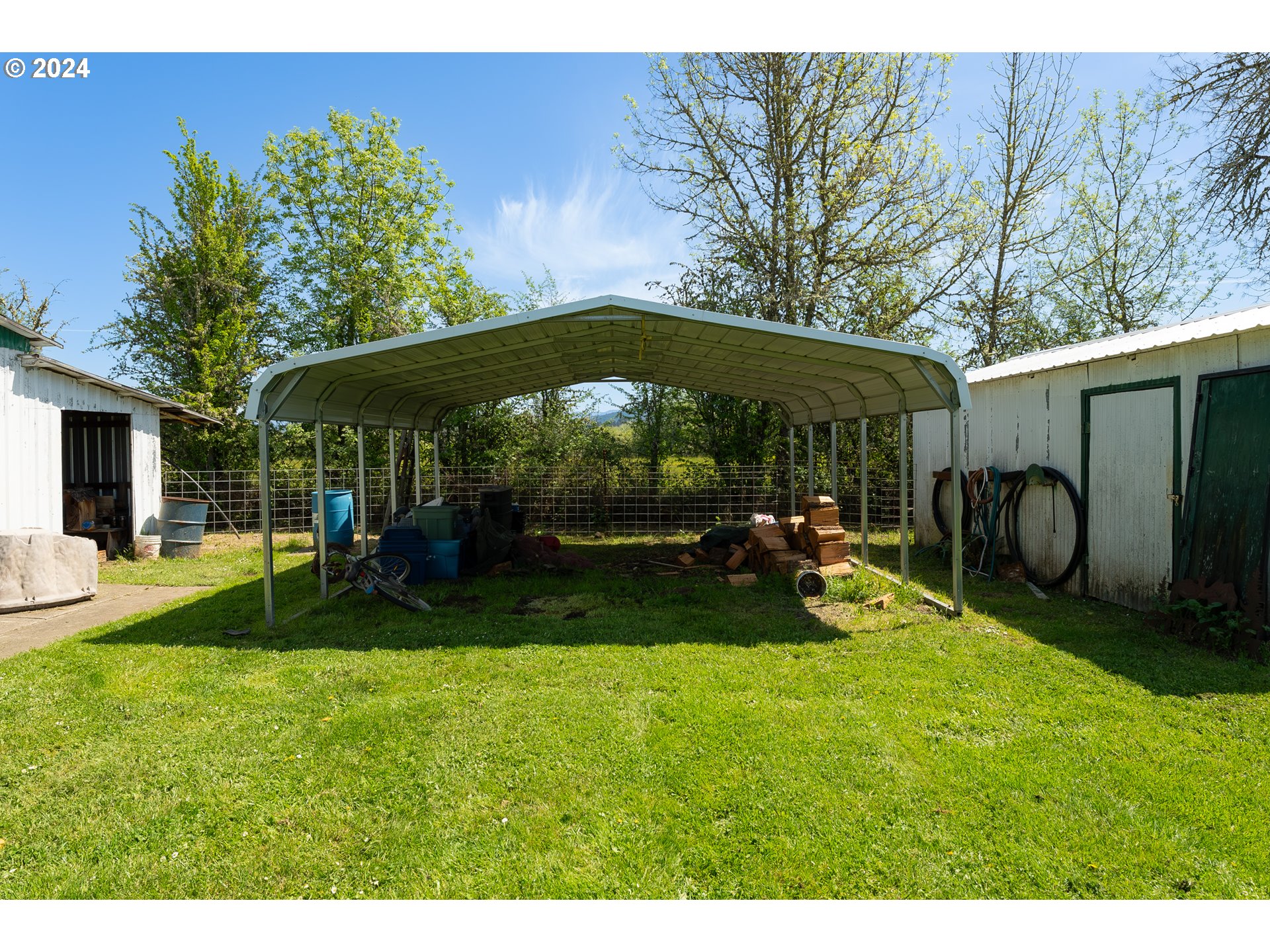 215 Northside Road Sutherlin, OR 97479 - Photo 30 of 40 a view of a backyard with table and chairs under an umbrella