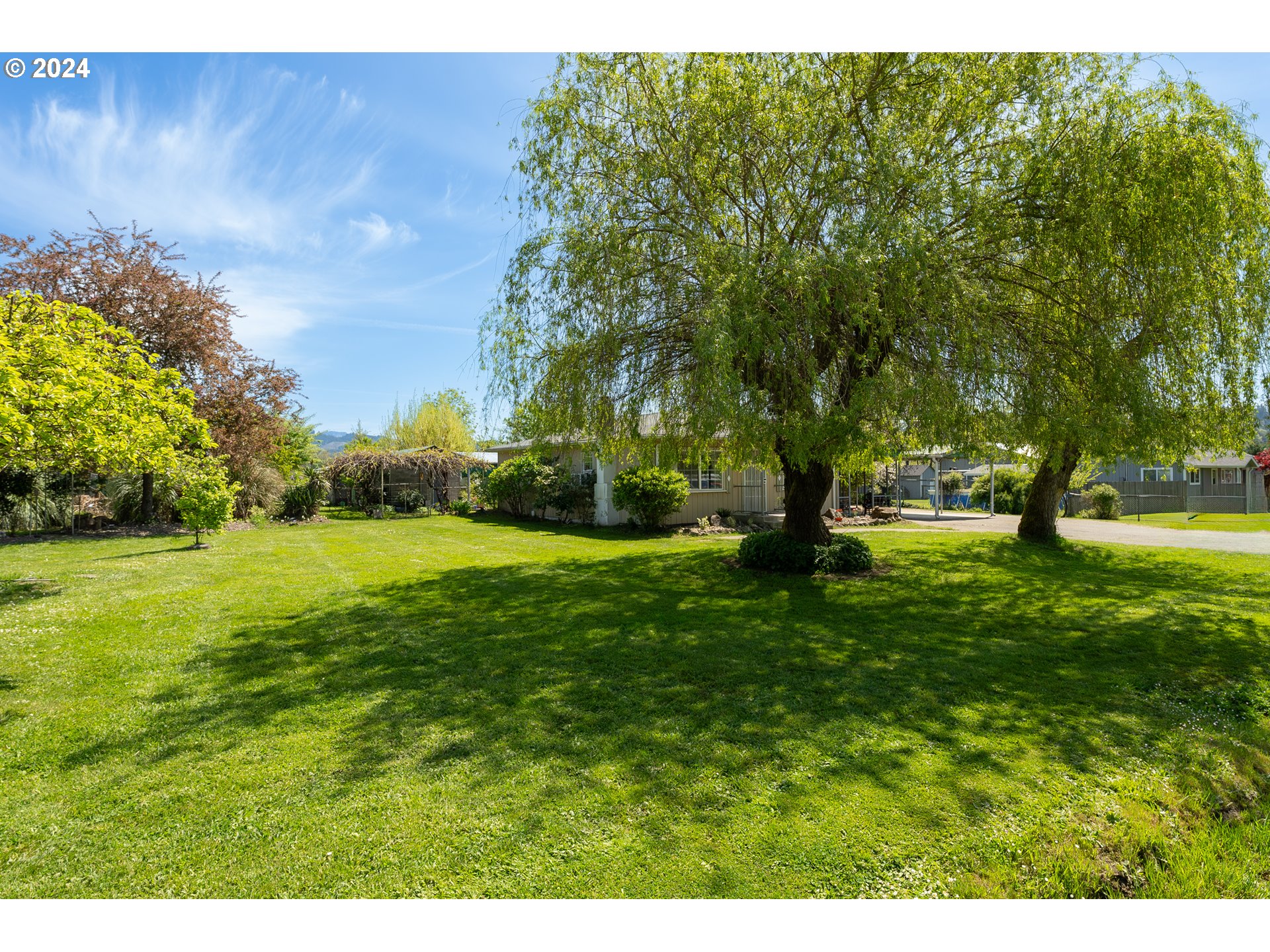 215 Northside Road Sutherlin, OR 97479 - Photo 4 of 40 a huge green field with lots of trees