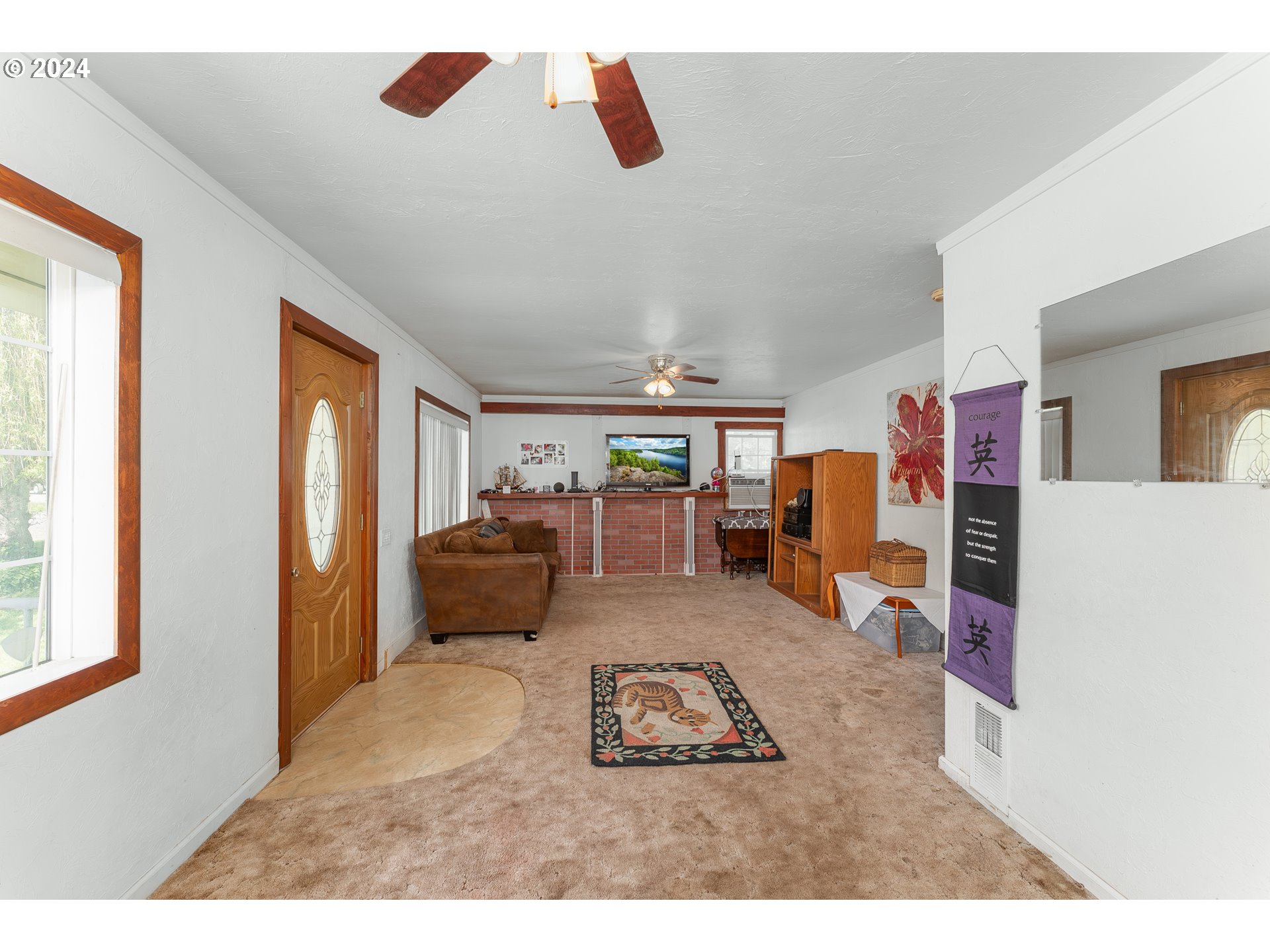 215 Northside Road Sutherlin, OR 97479 - Photo 9 of 40 a living room with furniture and a flat screen tv