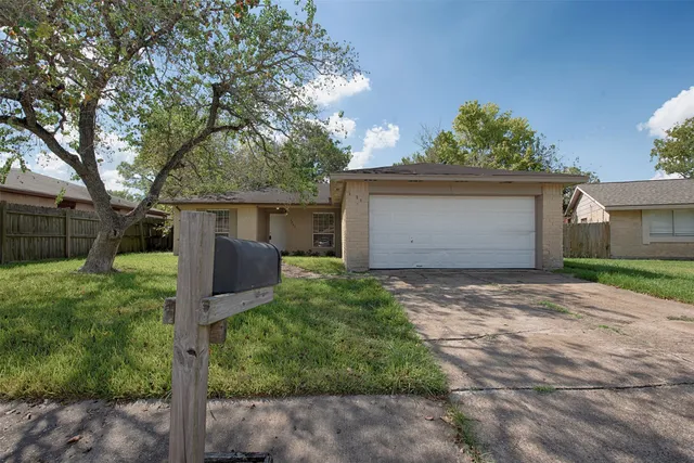 a front view of house with a garden