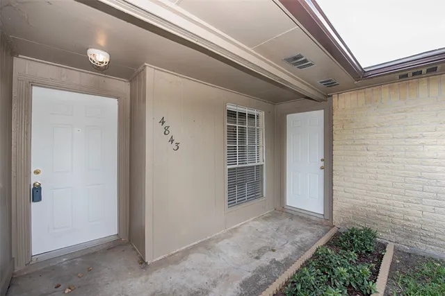 a backyard of a house with garden and outdoor seating