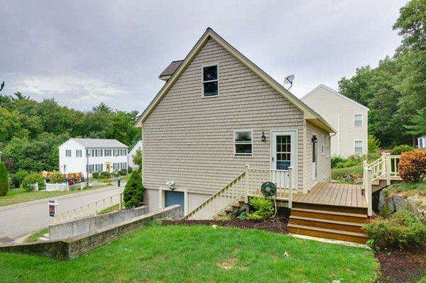 237 Acropolis Road Lowell, MA 01854 - Photo 19 of 22 a front view of a house with a garden and plants