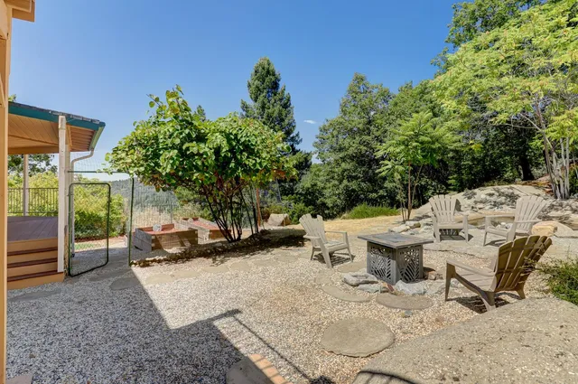 a large kitchen with stainless steel appliances granite countertop a sink a stove and a refrigerator