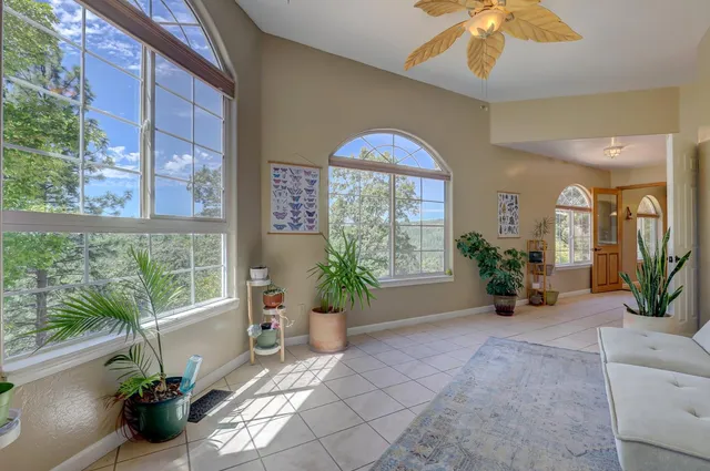 a living room with furniture a fireplace and a large window