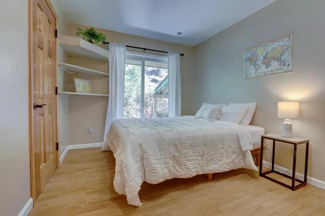 a bedroom with a bed and windows