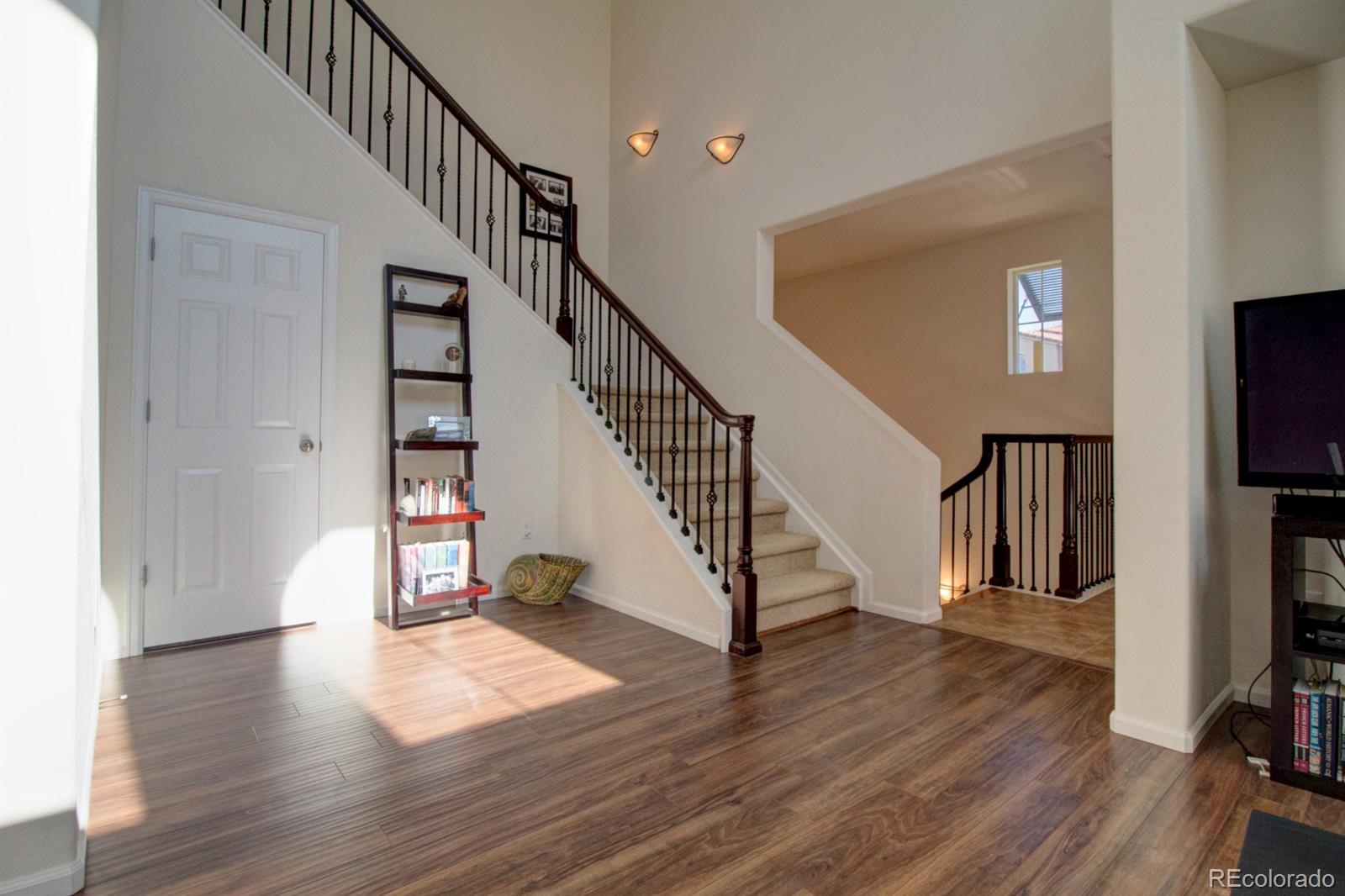 3491 Cascina Place, Unit D Highlands Ranch, CO 80126 - Photo 11 of 22 a view of entryway with wooden floor and stairs
