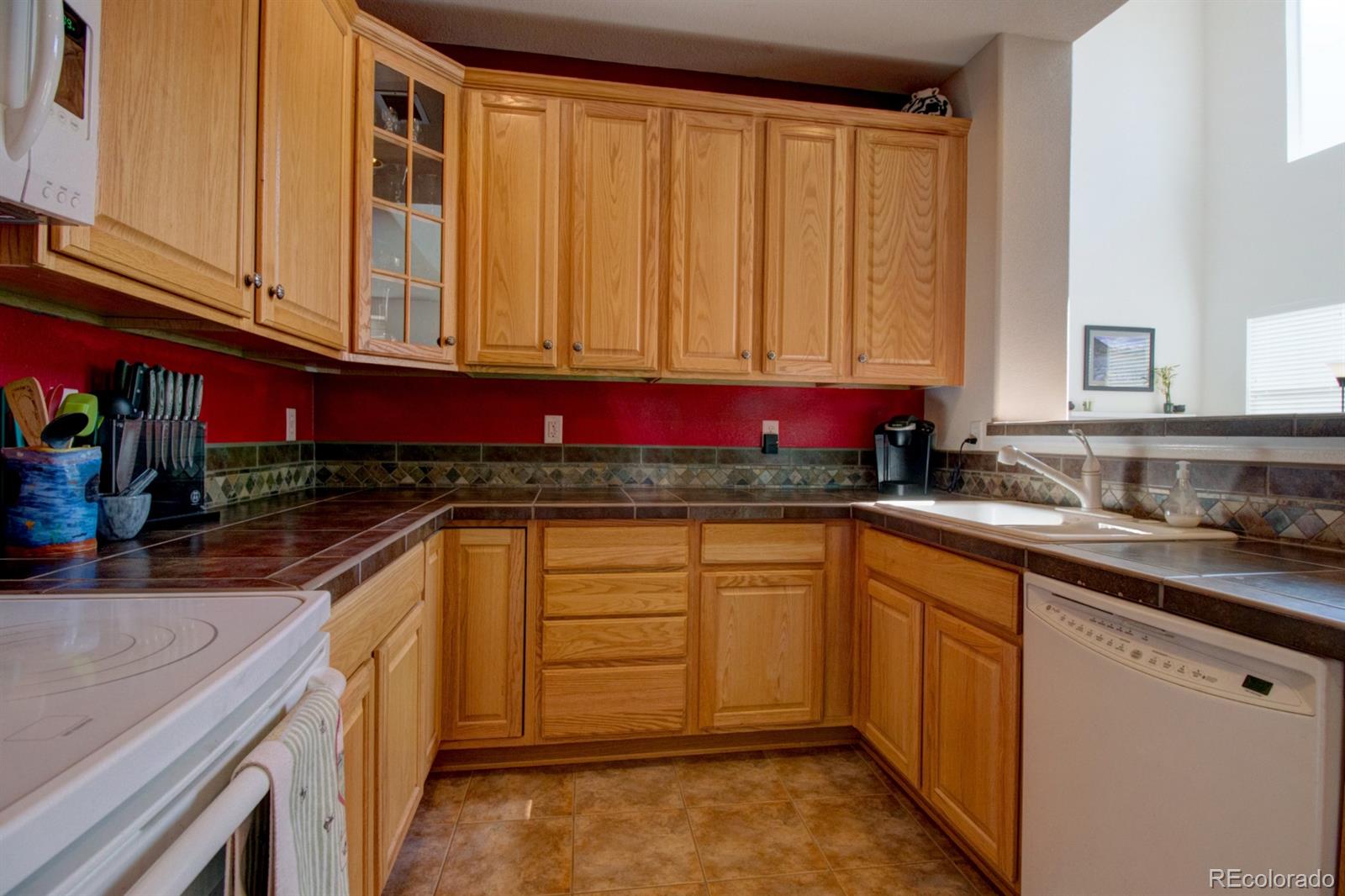 3491 Cascina Place, Unit D Highlands Ranch, CO 80126 - Photo 12 of 22 a kitchen with stainless steel appliances granite countertop a sink stove and cabinets