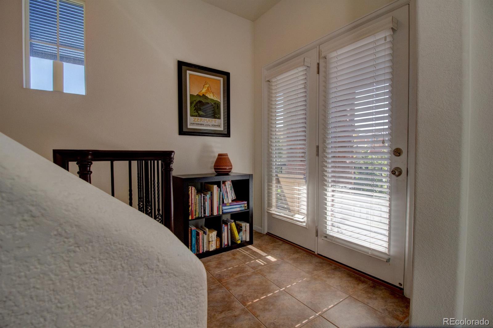 3491 Cascina Place, Unit D Highlands Ranch, CO 80126 - Photo 19 of 22 a view of a bedroom with furniture and staircase
