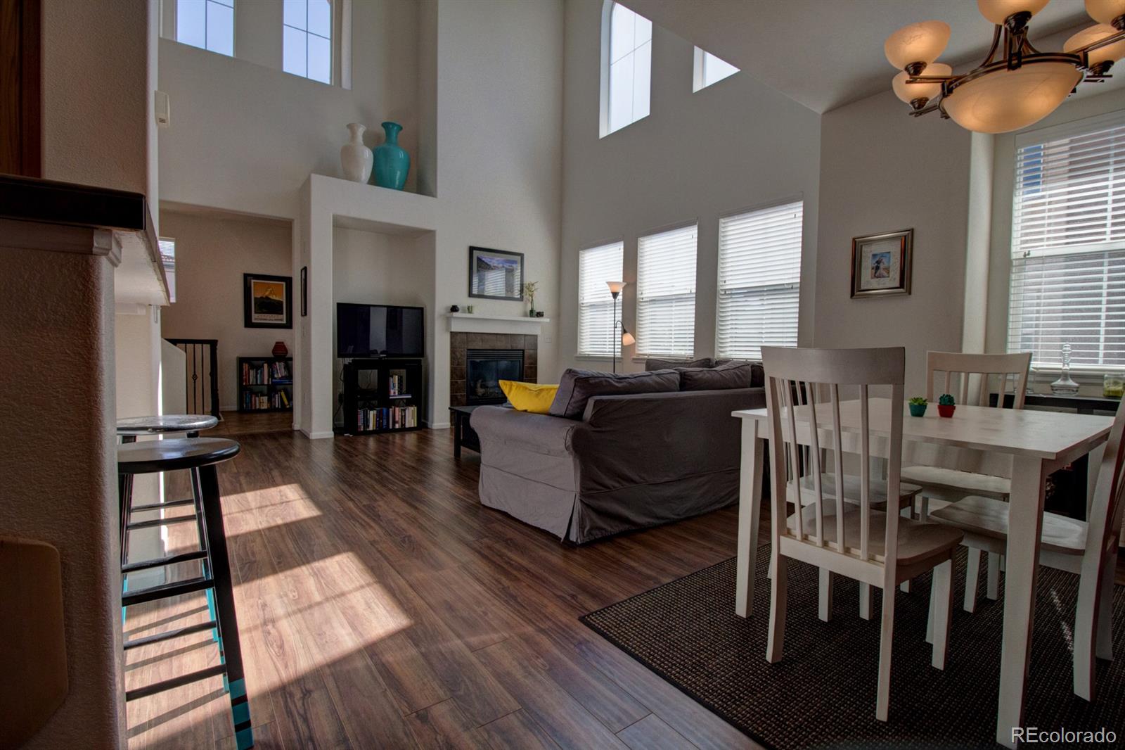 3491 Cascina Place, Unit D Highlands Ranch, CO 80126 - Photo 6 of 22 a living room with fireplace furniture and a wooden floor