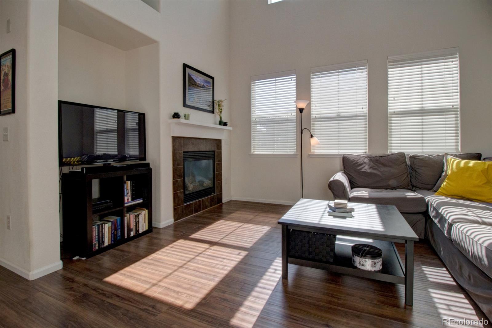 3491 Cascina Place, Unit D Highlands Ranch, CO 80126 - Photo 8 of 22 a living room with furniture a flat screen tv and a fireplace