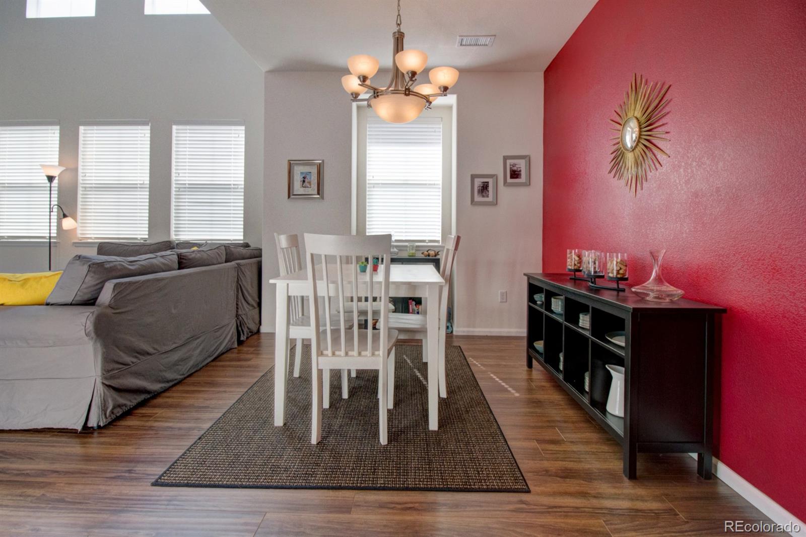 3491 Cascina Place, Unit D Highlands Ranch, CO 80126 - Photo 10 of 22 a dining room with wooden floor and a chandelier