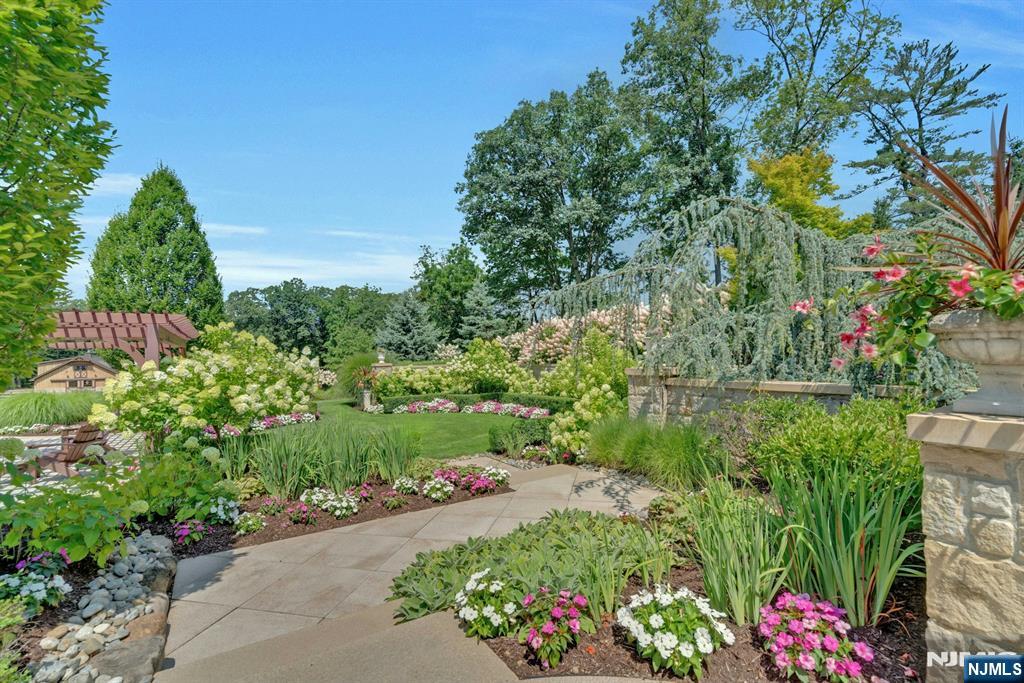 123 East Saddle River Road Saddle River, NJ 07458 - Photo 14 of 50 a view of a garden with plants and large trees