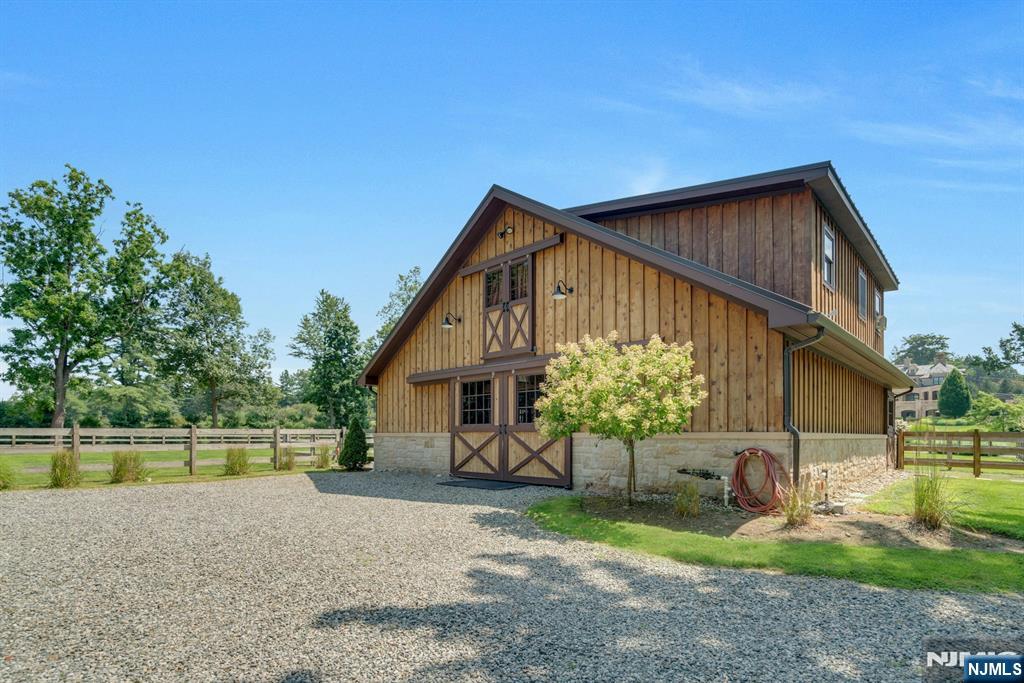123 East Saddle River Road Saddle River, NJ 07458 - Photo 19 of 50 a backyard of a house with table and chairs