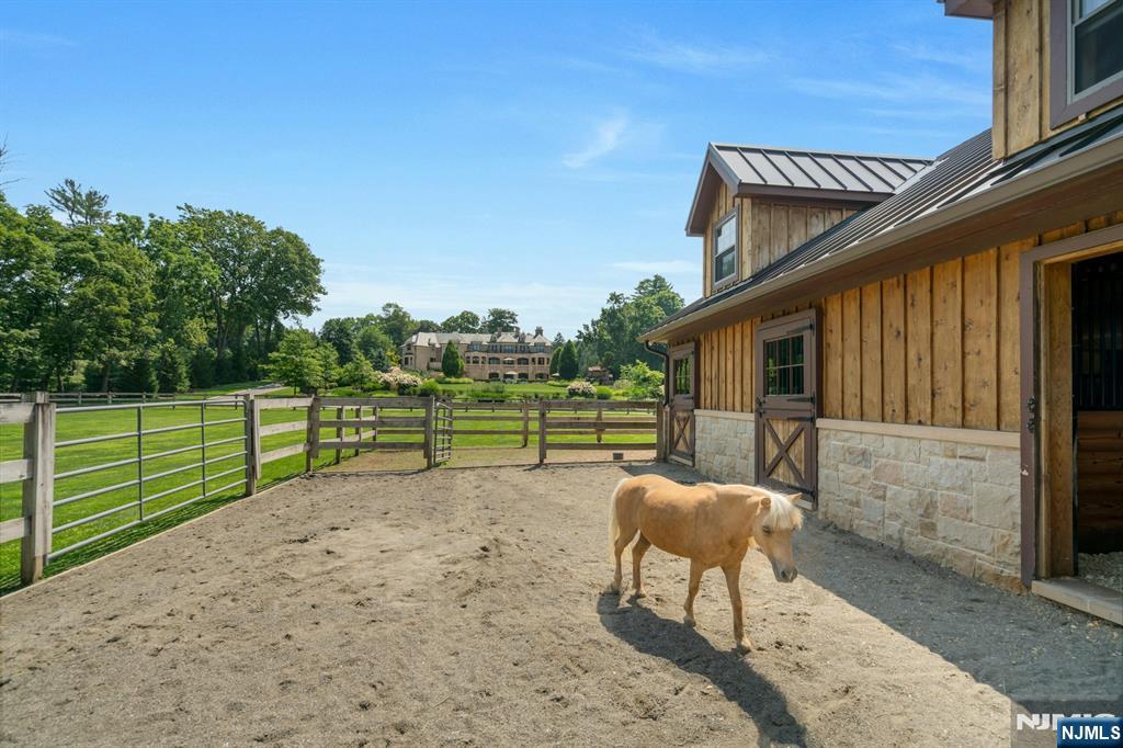 123 East Saddle River Road Saddle River, NJ 07458 - Photo 20 of 50 a backyard of a house with table and chairs