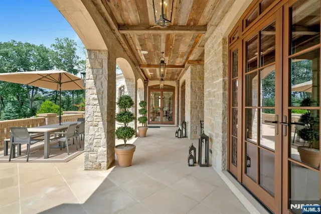a view of a porch with chairs and backyard