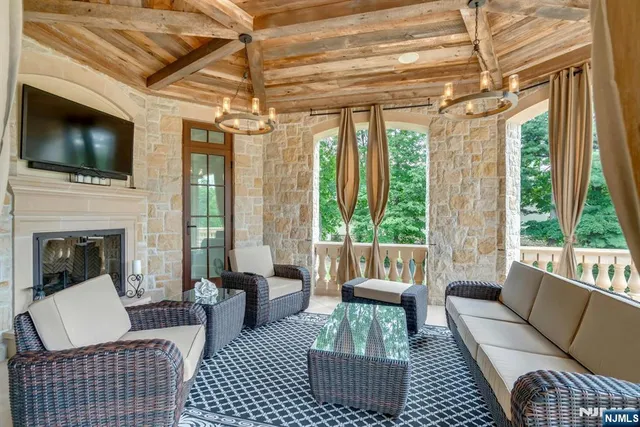 a living room with furniture a flat screen tv and a fireplace