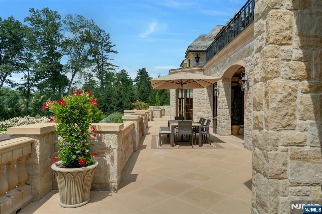 123 East Saddle River Road Saddle River, NJ 07458 - Photo 27 of 50 a view of a patio with table and chairs potted plants