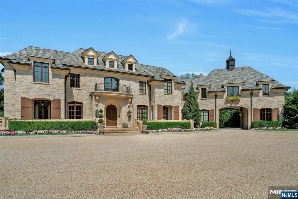 123 East Saddle River Road Saddle River, NJ 07458 - Photo 3 of 50 a front view of a house with a garden