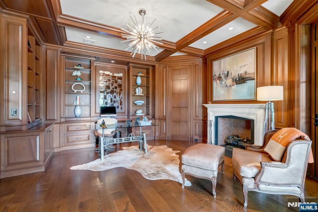 123 East Saddle River Road Saddle River, NJ 07458 - Photo 33 of 50 a living room with furniture a fireplace and large windows