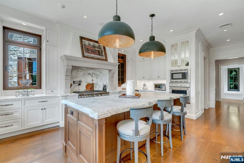 123 East Saddle River Road Saddle River, NJ 07458 - Photo 37 of 50 a kitchen with granite countertop wooden floor cabinets and dining table