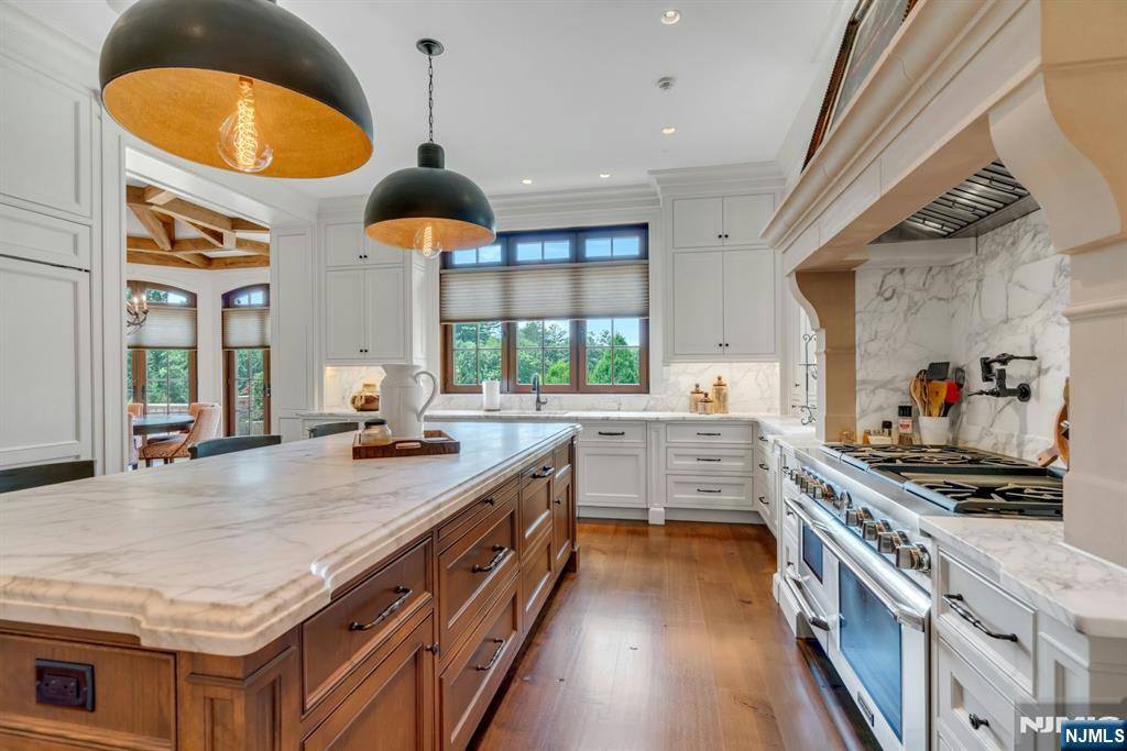 123 East Saddle River Road Saddle River, NJ 07458 - Photo 38 of 50 a kitchen with stainless steel appliances granite countertop a stove a sink and a wooden floors