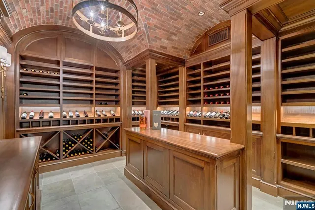 a kitchen with stainless steel appliances a stove a chimney and a sink