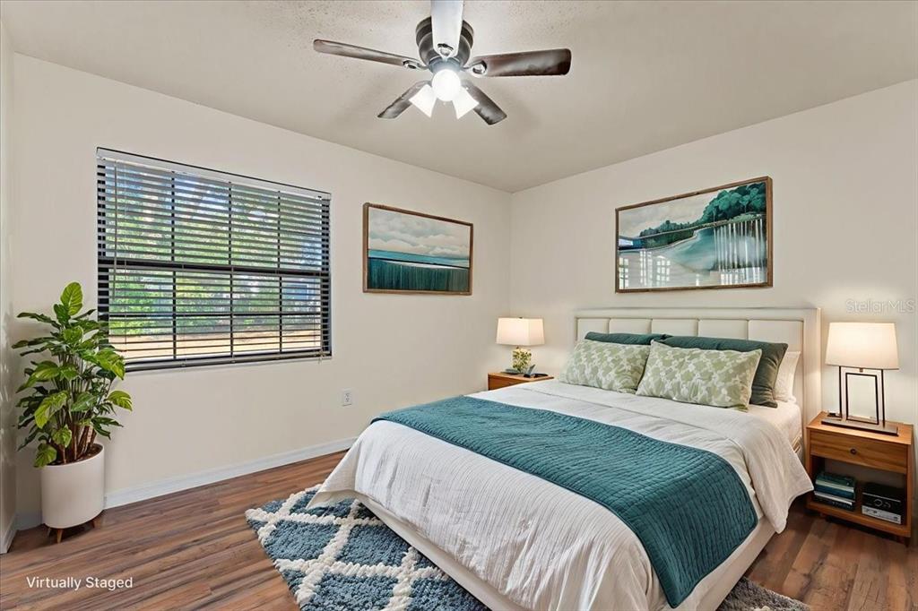 3701 Modesto Street New Port Richey, FL 34655 - Photo 13 of 41 a bedroom with bed and a potted plant