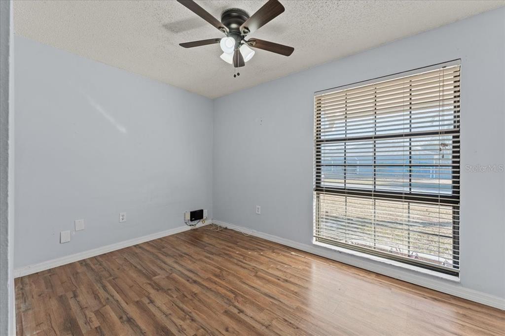 3701 Modesto Street New Port Richey, FL 34655 - Photo 17 of 41 a view of empty room with wooden floor and fan