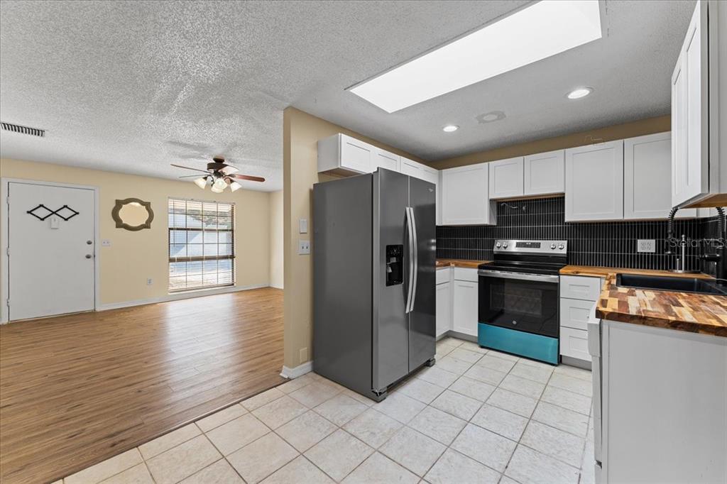 3701 Modesto Street New Port Richey, FL 34655 - Photo 20 of 41 a kitchen with granite countertop a refrigerator and a stove top oven