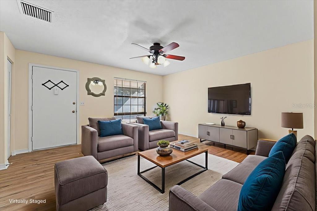3701 Modesto Street New Port Richey, FL 34655 - Photo 5 of 41 a living room with furniture a flat screen tv and a window