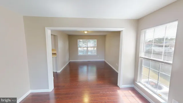 wooden floor in an empty room with a mirror