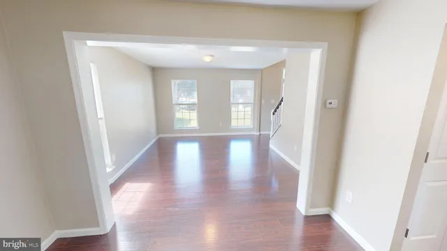 a kitchen with a sink a refrigerator a stove top oven and wooden floor