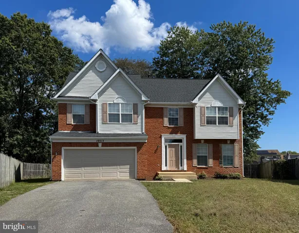 a front view of a house with a garden and yard