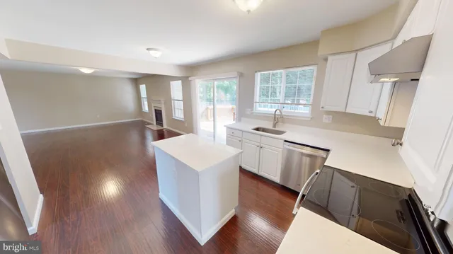 a view of a hallway with wooden floor and entryway