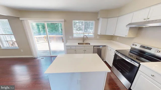 a view of an entryway with wooden floor