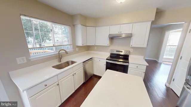 a view of a hallway with wooden floor and closet