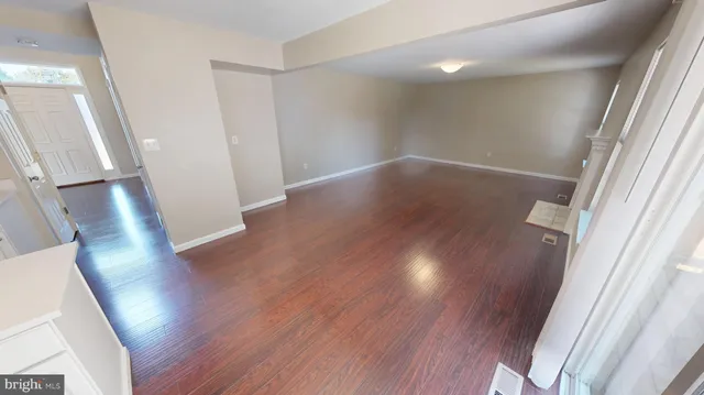 a view of a hallway with wooden floor and stairs