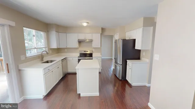a bathroom with a sink a toilet a mirror and vanity