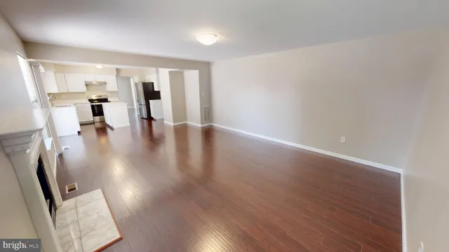 a bathroom with a tub a sink and a large mirror next to a window