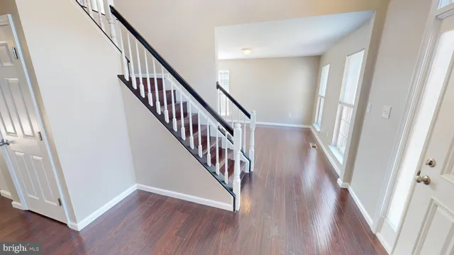 an empty room with wooden floor and closet