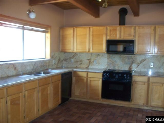 1713 Rice Road Fallon, NV 89406 - Photo 2 of 9 a kitchen with stainless steel appliances granite countertop a sink and a microwave