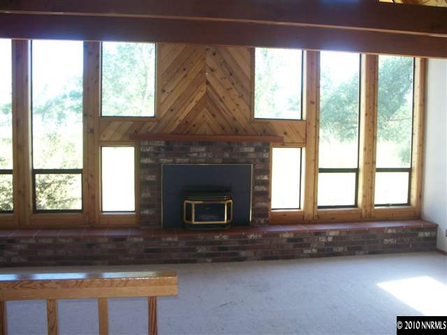 1713 Rice Road Fallon, NV 89406 - Photo 3 of 9 a living room with a fireplace and windows