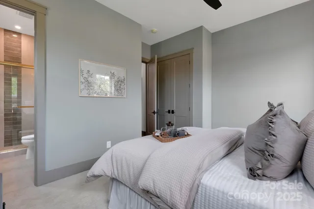 a bedroom with a bed and a painting on the wall