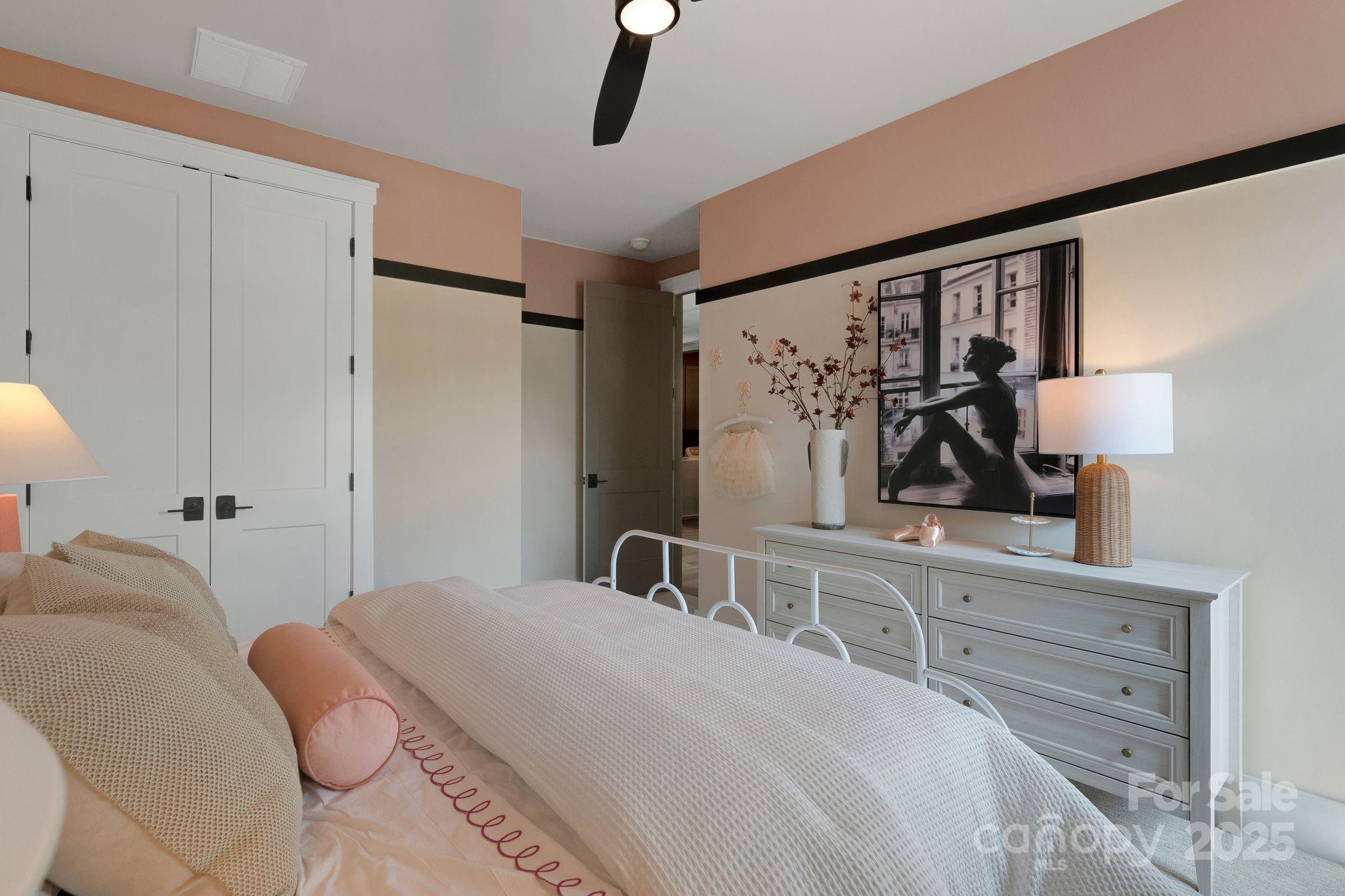 13648 Glennmayes Road Huntersville, NC 28078 - Photo 20 of 32 a bedroom with a bed and a lamp on dresser